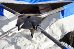 The fiberglass poles fit into the center attachment point at the top of the tent. This creates the top dome. 